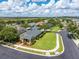 Aerial view showcasing a home in a tranquil residential neighborhood with mature trees at 303 White Water Bay Dr, Groveland, FL 34736