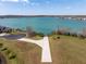 Stunning aerial view of a waterfront property with a beautiful lake and a private boat launch at 303 White Water Bay Dr, Groveland, FL 34736