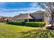 A spacious backyard featuring lush green grass and manicured hedges, perfect for outdoor enjoyment at 303 White Water Bay Dr, Groveland, FL 34736