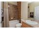 Bathroom with brown tiled shower and granite countertop at 303 White Water Bay Dr, Groveland, FL 34736