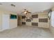 Large bonus room with neutral carpeting, ceiling fan, and decorative wall panels at 303 White Water Bay Dr, Groveland, FL 34736