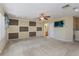 Spacious bonus room with carpet, a ceiling fan, and an ensuite bathroom at 303 White Water Bay Dr, Groveland, FL 34736