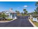 Gated community entrance with a guardhouse, security gate, and meticulously maintained landscaping at 303 White Water Bay Dr, Groveland, FL 34736