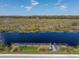 Community pier with dock offering scenic views of the adjacent marsh at 303 White Water Bay Dr, Groveland, FL 34736