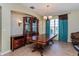 Elegant dining room with a large wooden table, china cabinet, and ample natural light from a window at 303 White Water Bay Dr, Groveland, FL 34736