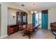 Traditional dining room featuring wood table, china cabinet, sconces, and large window at 303 White Water Bay Dr, Groveland, FL 34736