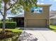 Two story home with two car garage, screened in patio, and well manicured lawn at 303 White Water Bay Dr, Groveland, FL 34736