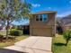 Two story home featuring a two car garage, driveway, green lawn, and mature trees at 303 White Water Bay Dr, Groveland, FL 34736