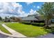 Beautiful single-Gathering home featuring lush lawn, mature landscaping and a screened-in lanai at 303 White Water Bay Dr, Groveland, FL 34736