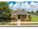Charming single-Gathering home featuring a well-manicured lawn, beautiful landscaping, and inviting front porch at 303 White Water Bay Dr, Groveland, FL 34736