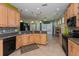Spacious kitchen featuring granite countertops, tile backsplash, stainless appliances, and ample cabinet space at 303 White Water Bay Dr, Groveland, FL 34736