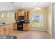 Eat-in kitchen featuring tiled floors, updated appliances, and natural light at 303 White Water Bay Dr, Groveland, FL 34736