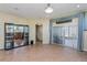 Open-concept living room with tile floors, recessed lighting, and sliding glass doors at 303 White Water Bay Dr, Groveland, FL 34736