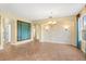 Spacious living room featuring tile floors, decorative walls, and a view to other rooms at 303 White Water Bay Dr, Groveland, FL 34736