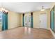 Bright living room with tile floors, French doors, and a ceiling fan at 303 White Water Bay Dr, Groveland, FL 34736