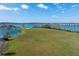 Large open field, perfect for recreational activities, featuring lake views at 303 White Water Bay Dr, Groveland, FL 34736