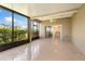 Spacious screened lanai with tile floors, ceiling fan, and sliding door access to the home at 303 White Water Bay Dr, Groveland, FL 34736