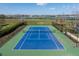 Aerial view of a well-maintained tennis court with a view of the lake at 303 White Water Bay Dr, Groveland, FL 34736