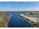 Scenic community waterfront views with a dock, lush vegetation and neighborhood homes at 303 White Water Bay Dr, Groveland, FL 34736