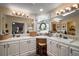 Spacious primary bath vanity featuring dual sinks, ample counter space, and well-lit mirrors at 313 Westwood Dr, Leesburg, FL 34748