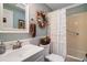 Bathroom featuring a vanity, stylish mirror, and decorative shower curtain, designed for comfort at 313 Westwood Dr, Leesburg, FL 34748