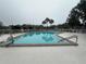 Inviting community pool surrounded by lounge chairs and lush landscaping at 313 Westwood Dr, Leesburg, FL 34748