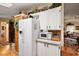 Traditional kitchen featuring white cabinets, modern microwave, and wooden countertops at 313 Westwood Dr, Leesburg, FL 34748