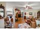 Comfortable living room with hardwood floors, ceiling fan, and an open-concept kitchen at 313 Westwood Dr, Leesburg, FL 34748