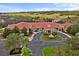 Aerial view of the community clubhouse, featuring a grand entrance and manicured landscaping at 3206 Sonesta Ct # A, Clermont, FL 34711