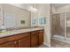 Bathroom featuring granite countertop vanity and glass-enclosed shower at 3206 Sonesta Ct # A, Clermont, FL 34711