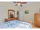 Bedroom with hard wood floors, ceiling fan, and a wooden bed frame at 3206 Sonesta Ct # A, Clermont, FL 34711