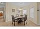 Cozy dining area features a round wood table, chandelier, and neutral decor at 3206 Sonesta Ct # A, Clermont, FL 34711