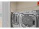 Modern laundry room featuring a large, front-loading washer and dryer set at 3206 Sonesta Ct # A, Clermont, FL 34711