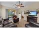 The living room showcases tile flooring, a ceiling fan, and sliding glass doors at 3206 Sonesta Ct # A, Clermont, FL 34711