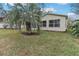 Lawn and palm tree on the backyard of a home featuring a screened-in patio at 32222 Summertree Circle, Leesburg, FL 34748