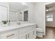 Bathroom vanity with white marble countertop, gold hardware, and decorative wallpaper at 32222 Summertree Circle, Leesburg, FL 34748