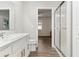 Bright bathroom with a white vanity, gold hardware, and modern glass shower at 32222 Summertree Circle, Leesburg, FL 34748