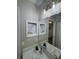 Bathroom vanity with white countertop, and built-in shelf in the mirror at 32222 Summertree Circle, Leesburg, FL 34748