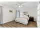 Inviting bedroom features wood-look floors, ceiling fan, and a neutral color scheme at 32222 Summertree Circle, Leesburg, FL 34748