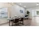 Bright dining room features modern light fixture, seating for four, and luxury vinyl plank flooring at 32222 Summertree Circle, Leesburg, FL 34748