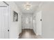 Bright foyer with wood-look floors, a decorative light fixture, and a view of the front door at 32222 Summertree Circle, Leesburg, FL 34748