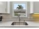 Close up of the kitchen sink with a stainless steel faucet and marble countertops at 32222 Summertree Circle, Leesburg, FL 34748