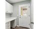 Laundry room with white cabinets, gold hardware, and a built-in folding counter at 32222 Summertree Circle, Leesburg, FL 34748