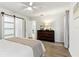 Main bedroom with a ceiling fan, dresser and ensuite bathroom at 32222 Summertree Circle, Leesburg, FL 34748