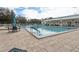 Large community pool with seating and lounge chairs on the paved pool deck at 32222 Summertree Circle, Leesburg, FL 34748