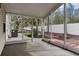 View of the screened patio with concrete flooring and access to the landscaped backyard with privacy fence at 32222 Summertree Circle, Leesburg, FL 34748