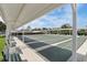 View of multiple outdoor shuffleboard courts with a white awning providing shade and green benches at 32222 Summertree Circle, Leesburg, FL 34748