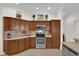 Well-equipped kitchen featuring stainless steel appliances, ample counter space, and wooden cabinets at 3262 Dalkeith Ter, The Villages, FL 32163