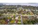 Aerial view of a single-Gathering home near a lake, showcasing the neighborhood layout and proximity to the water at 330 N Sunset Dr, Mount Dora, FL 32757