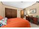 A cute bedroom featuring a desk, chair and double closet at 330 N Sunset Dr, Mount Dora, FL 32757